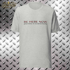 Grey heather tshirt with "Be here now" and the thin red line above the caption "Nothing is guaranteed" with a skull at each end of the text.