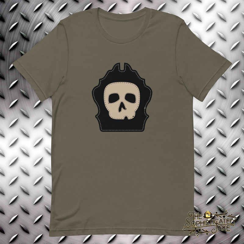 Army colored shirt with graphic in the center of the chest.  Image is of a decorative firefighter helmet shield with a skull.  Accents make it look like a helmet shield that has been stitched together.